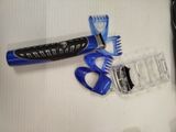 a picture of a blue and black electric shaver and comb