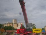 a red crane that is sitting on the back of a truck
