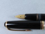 two pens sitting next to each other on a table