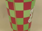 a green and red cup with a red and green checkered pattern