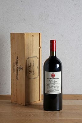 a bottle of wine sitting next to a wooden box