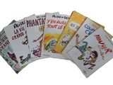 Plusieurs livres pour enfants sont alignés sur une surface blanche