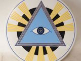 an image of a decorative plate with an all seeing eye
