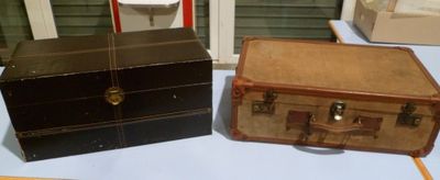 two old suitcases sitting on a table next to each other