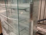 a glass display case in the middle of a pallet