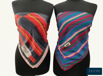 pair of mannequins with multicolored scarves on them