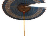 a blue and white umbrella that is on a pole