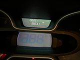 a car dashboard with a digital clock on it