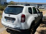 a white car that is parked on the side of the road