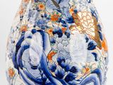 a blue and white vase with a picture of a woman on it