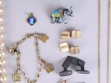 many different types of jewelry on a white surface