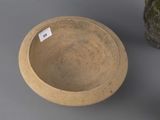 a small bowl sitting next to a larger bowl on a table