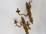 pair of antique brass wall sconces on a white background