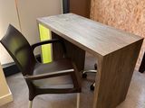 a desk with a chair in front of it in a room