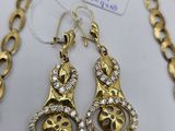 a gold necklace and earring set with a gold chain