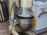 a mixer sitting on a pallet next to a stove