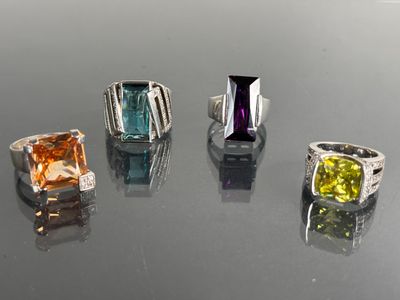 four different colored stones are arranged in a row on a table