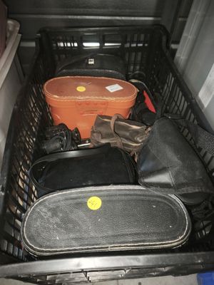 several pieces of luggage are sitting in a basket in the back of a car