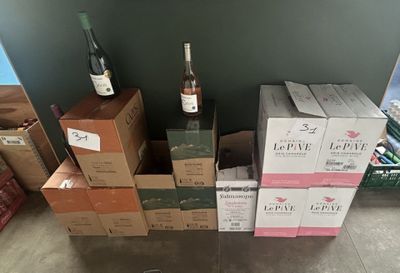 several boxes of wine are stacked on top of each other in a room