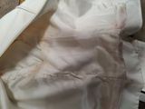 a close up of a white jacket on a table