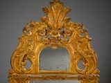 a mirror that is sitting on a table with a gold frame