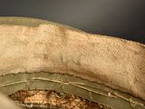 a close up of a military hat with a hole in it