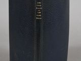 a black book sitting on top of a table next to a white wall