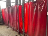 many red privacy screens in a room with windows