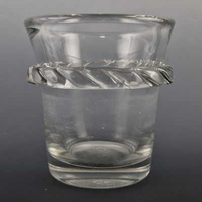a glass vase with a rope around it on a table