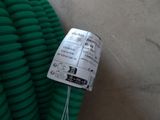 a bunch of green hoses sitting on the floor