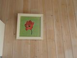 a picture of a picture of a red flower on the wall