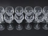 a set of six crystal wine glasses on a black surface