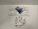 a lot of pens and a cell phone on the table