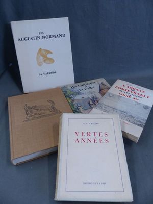 several books are sitting on a blue cloth covered surface