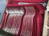 a lot of spoons and forks in a box