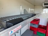 a conveyor belt with a bunch of boxes on it