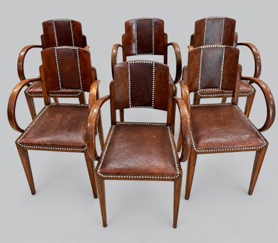 a set of four leather chairs with wooden arms and arms