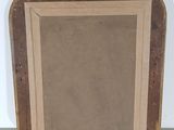an old picture frame sitting on top of a white wall