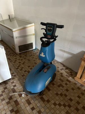 a blue scooter that is sitting in a room