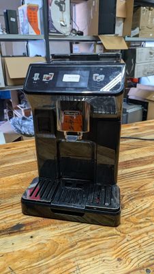 a coffee maker sitting on a wooden table in a room