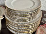 a stack of plates and cups on a table