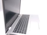 a silver laptop computer sitting on a white surface
