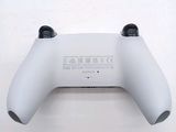 a close up of a wii controller on a white surface
