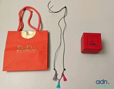 a red bag and a red necklace on a table