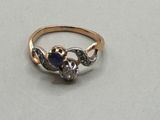 a close up of a gold ring with a blue stone on it