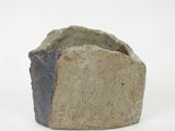a stone that is sitting on a white surface