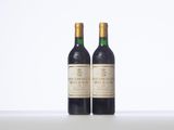 two bottles of wine sitting next to each other on a table