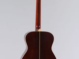 an acoustic guitar hanging from a wall