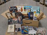 a box full of books sitting on top of a floor in a warehouse