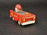 a small toy car with a fireman on top of it